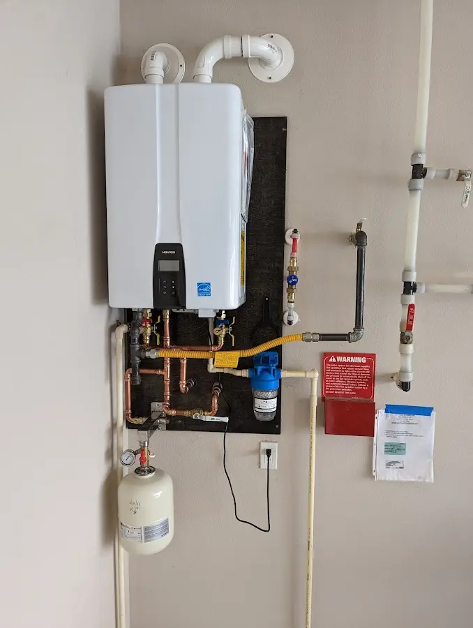 Professional plumber installing copper piping in a Heber home